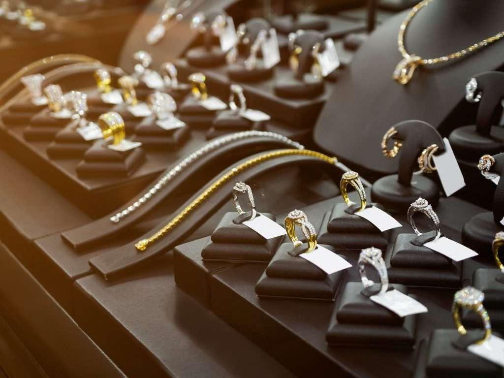 gallery display of diamond rings and necklaces in white and yellow gold