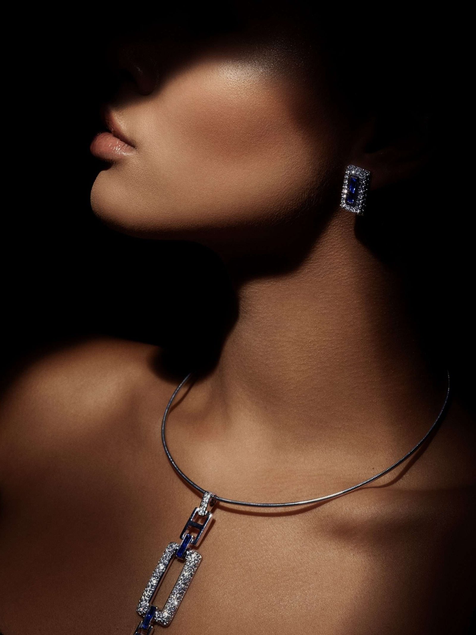 woman in shadow wearing luxury diamond jewelry