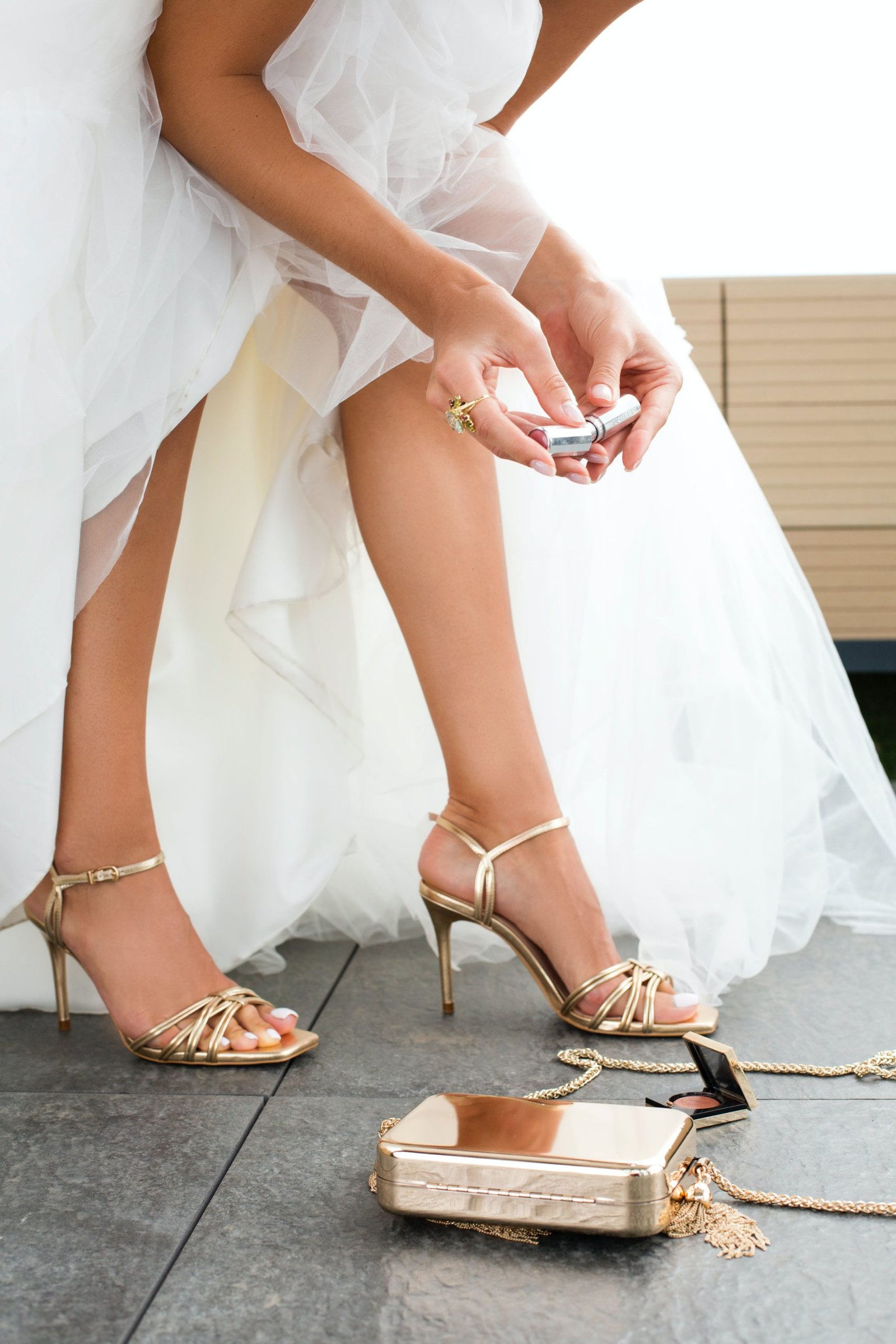 woman in wedding dress wearing diamond ring going through purse